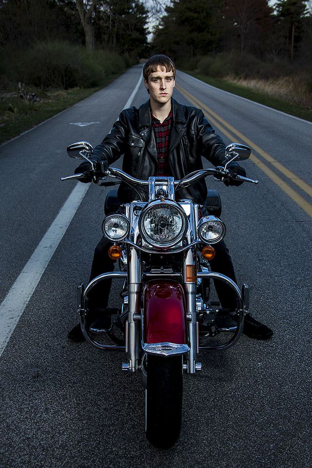 Senior portrait of young man riding a motorcycle at Presque Isle State Park in Erie, PA